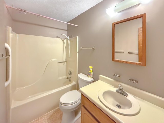 full bathroom with vanity, washtub / shower combination, a textured ceiling, and toilet