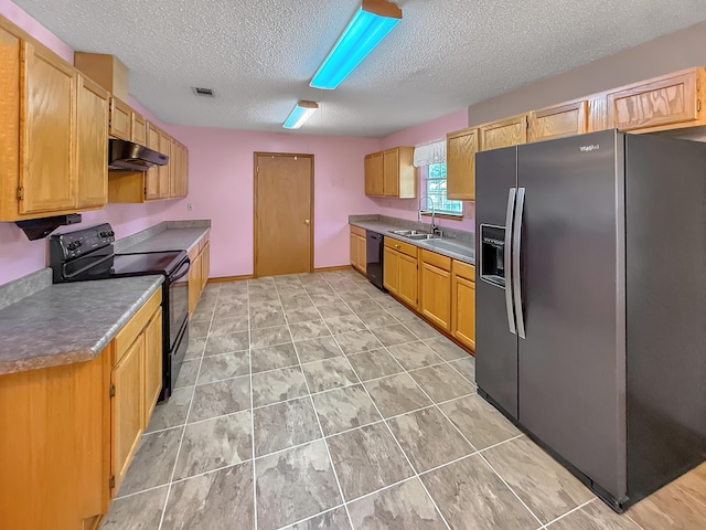 kitchen featuring light tile patterned flooring, sink, a textured ceiling, and black appliances