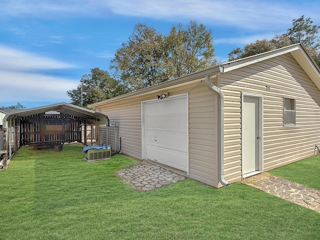 garage featuring a yard and a carport