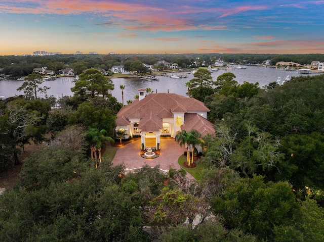 aerial view at dusk with a water view