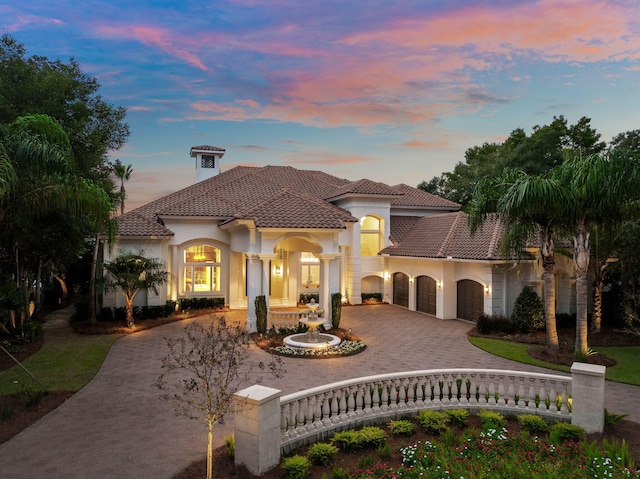 mediterranean / spanish-style house with a garage