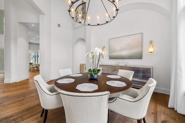 dining space with a chandelier and dark wood-type flooring