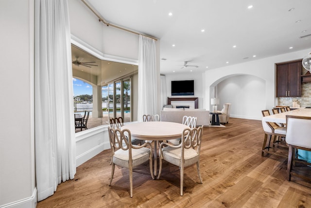 dining area with ceiling fan and light wood-type flooring