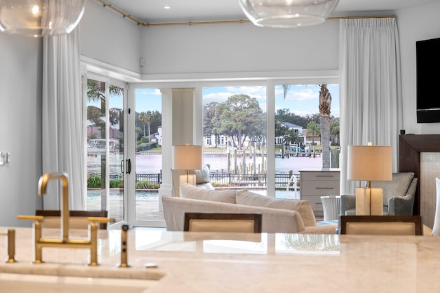 interior space featuring sink, a water view, and a healthy amount of sunlight