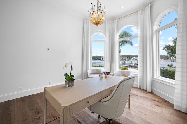 home office featuring light hardwood / wood-style flooring, a notable chandelier, and ornamental molding