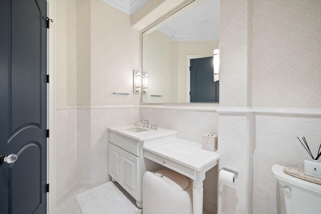 bathroom featuring vanity, toilet, and ornamental molding