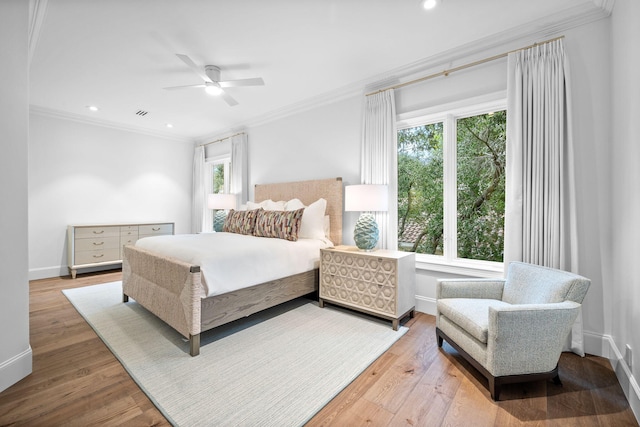 bedroom with hardwood / wood-style floors, ceiling fan, and crown molding