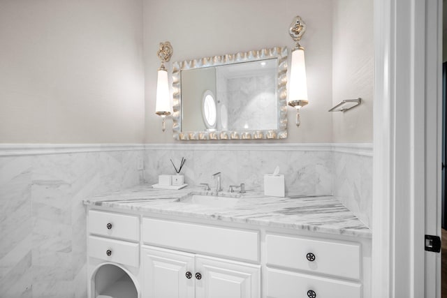 bathroom featuring vanity and tile walls