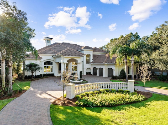 mediterranean / spanish home featuring a front lawn