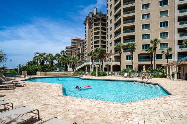 view of swimming pool with a patio