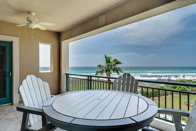 balcony with ceiling fan, a water view, and a beach view