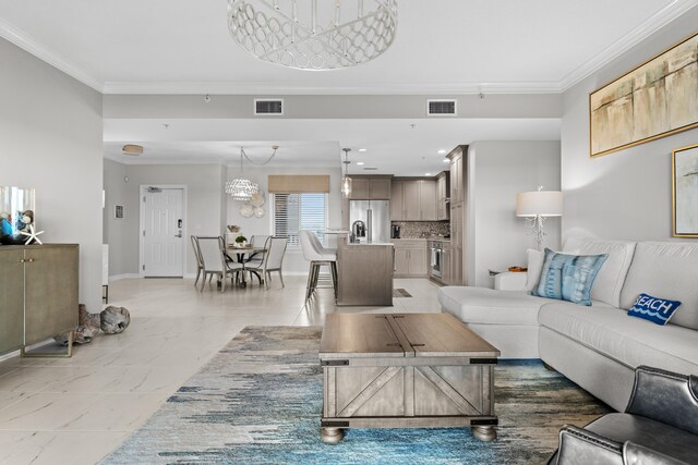 living room featuring sink, a chandelier, and ornamental molding