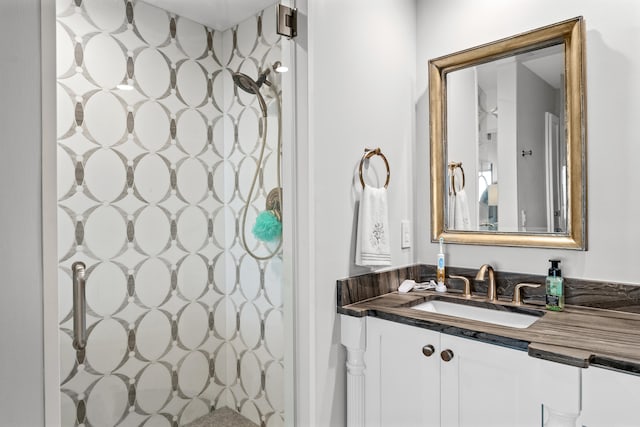 bathroom with a shower and vanity