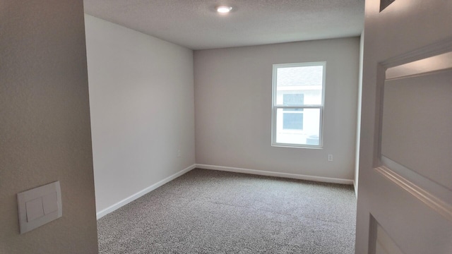 empty room featuring carpet floors and a textured ceiling