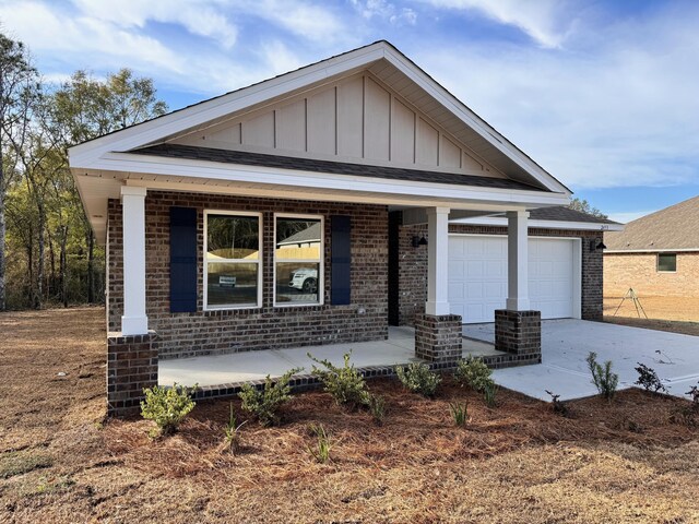 view of front of property featuring a porch and a garage