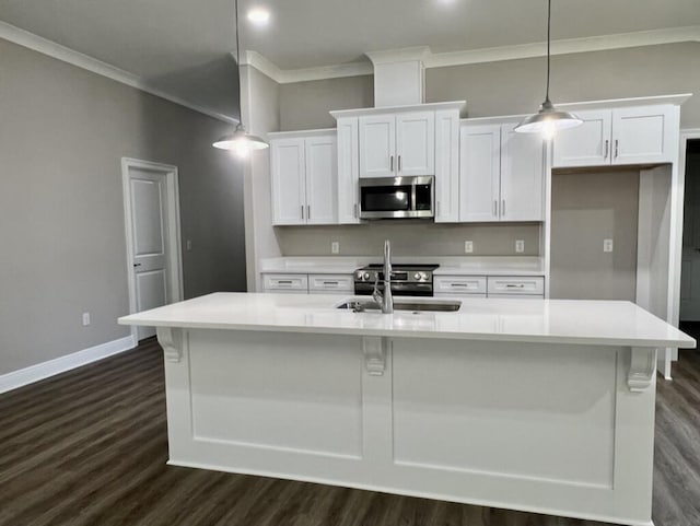 8405 Sevilla St, Navarre, FL 32566 - kitchen with stainless steel microwave, ornamental molding, dark wood-type flooring, a sink, and white cabinets