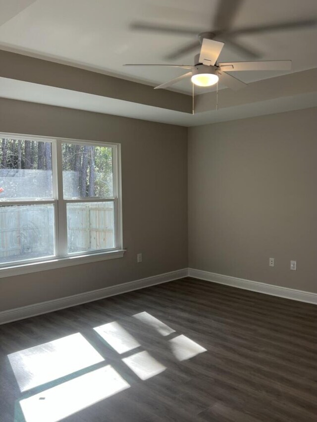 8405 Sevilla St, Navarre, FL 32566 - spare room with dark wood-type flooring, baseboards, and ceiling fan