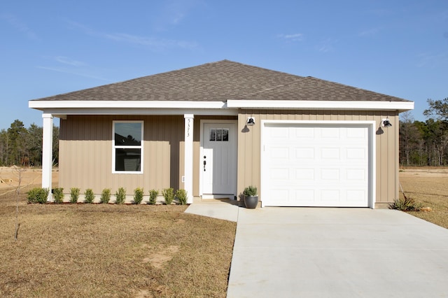 ranch-style home with a garage, driveway, and roof with shingles