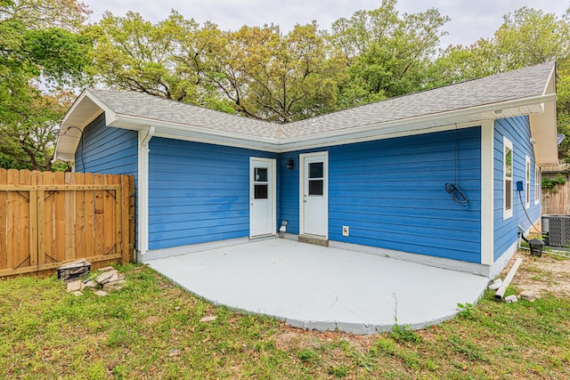 1013 Gloria Ave, Fort Walton Beach, FL 32547 - view of front of house with a patio area, fence, a shingled roof, and central AC unit