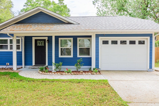 1013 Gloria Ave, Fort Walton Beach, FL 32547 - ranch-style house with a garage, concrete driveway, a shingled roof, and a front lawn