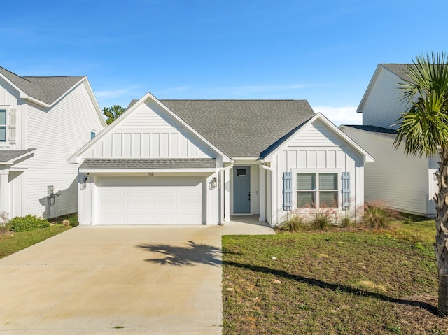 view of front of house with a garage and a front lawn