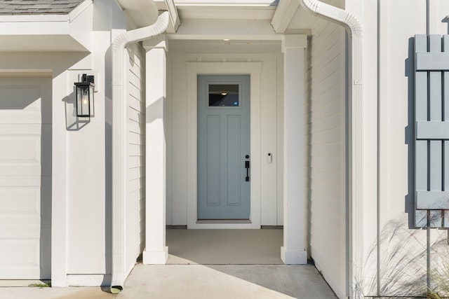 doorway to property with a garage