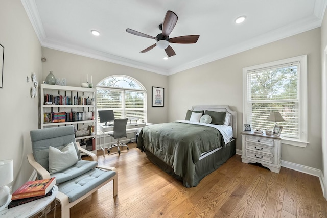 bedroom with ceiling fan, light wood-type flooring, crown molding, and multiple windows