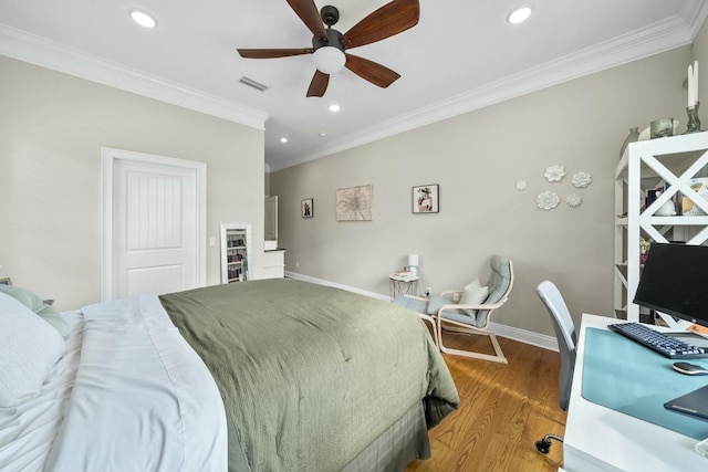 bedroom with a closet, ceiling fan, crown molding, and hardwood / wood-style flooring