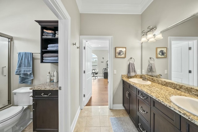 bathroom with tile patterned flooring, vanity, toilet, and ornamental molding