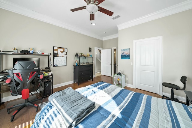 bedroom with ceiling fan, dark hardwood / wood-style flooring, and ornamental molding