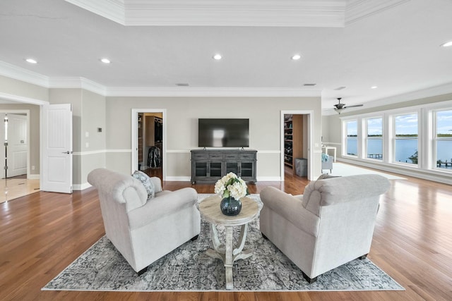 living room with ceiling fan, wood-type flooring, and ornamental molding