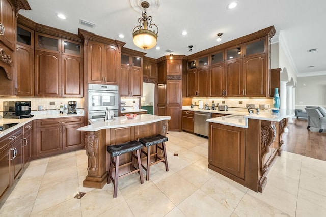 kitchen with a center island, stainless steel appliances, a breakfast bar area, and tasteful backsplash