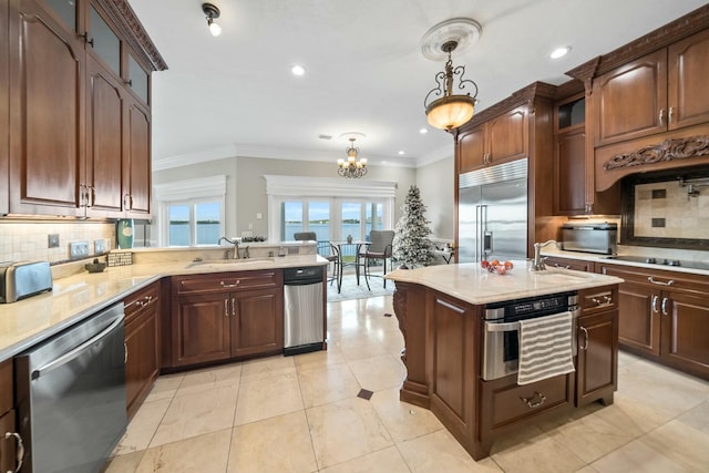 kitchen featuring tasteful backsplash, stainless steel appliances, crown molding, sink, and hanging light fixtures