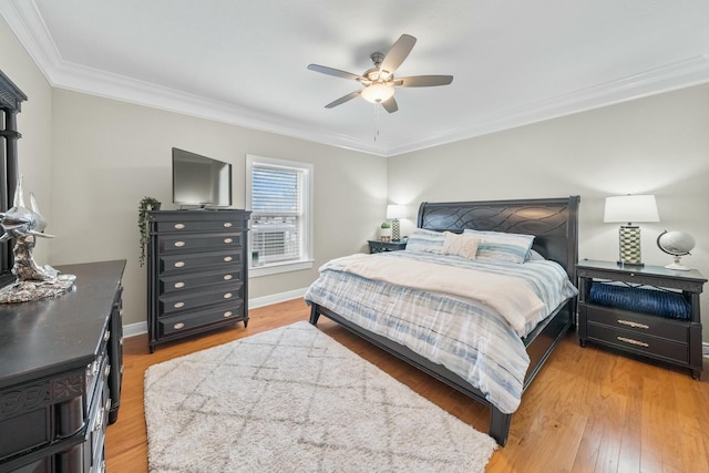 bedroom featuring ceiling fan, light hardwood / wood-style floors, and ornamental molding