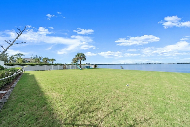 view of yard with a playground and a water view