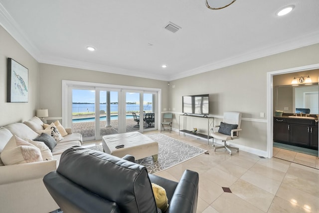 tiled living room featuring french doors, crown molding, and sink