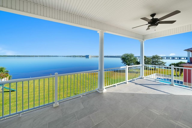 view of patio / terrace with ceiling fan, a balcony, and a water view