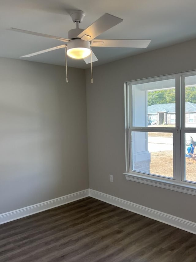 empty room featuring ceiling fan and dark hardwood / wood-style floors