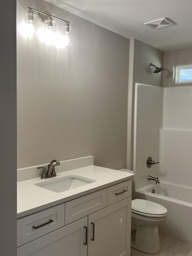 full bathroom featuring shower / bathing tub combination, toilet, and vanity