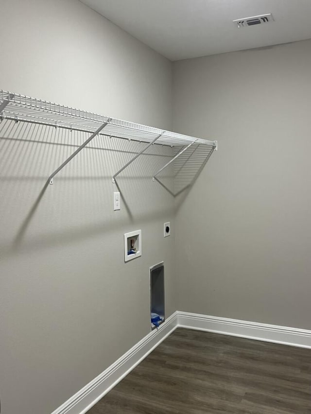 laundry area featuring dark hardwood / wood-style flooring, hookup for a washing machine, and electric dryer hookup