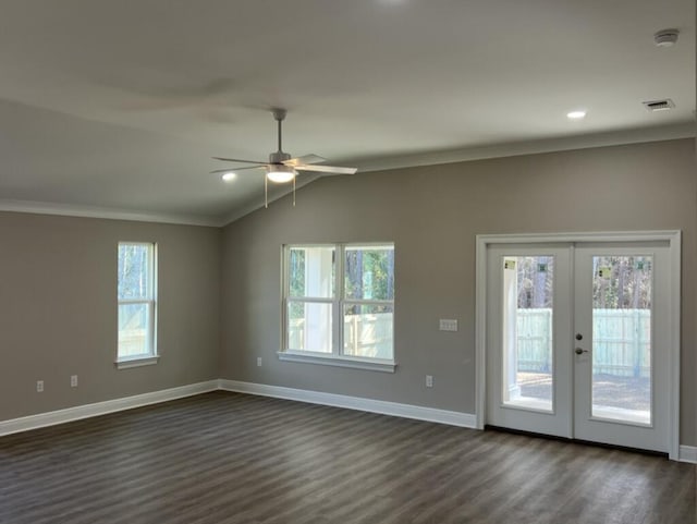 interior space featuring lofted ceiling, ceiling fan, dark wood-type flooring, ornamental molding, and french doors