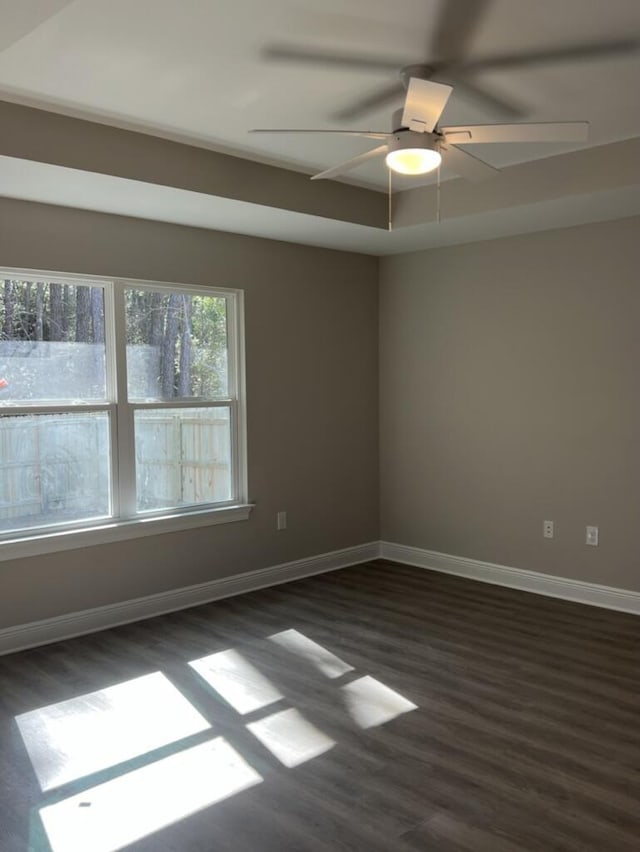 unfurnished room featuring ceiling fan and dark hardwood / wood-style floors