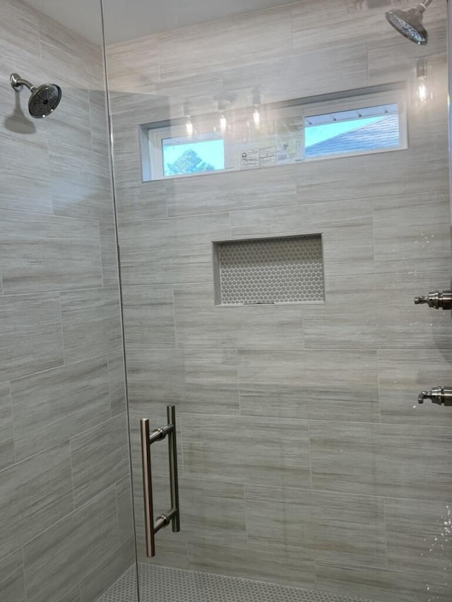 bathroom with a healthy amount of sunlight and a shower with door