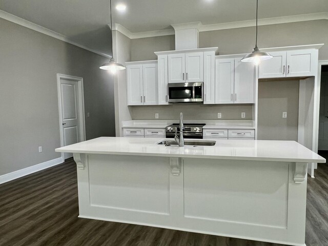 8417 Sevilla St, Navarre, FL 32566 - kitchen featuring white cabinetry, ornamental molding, a sink, and stainless steel microwave