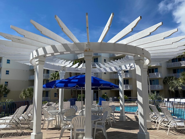view of patio with a pergola and a community pool