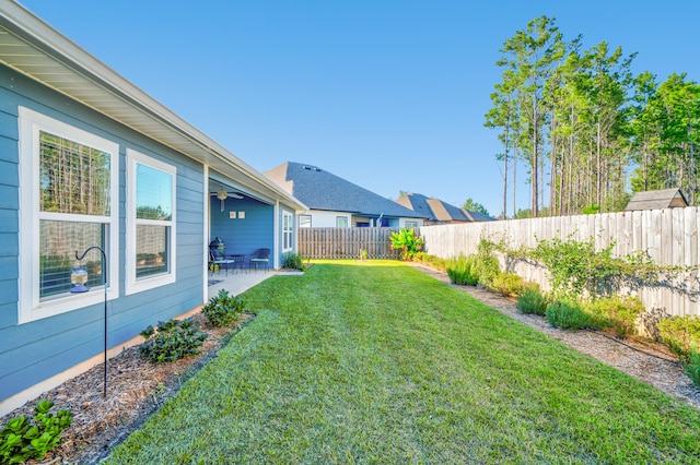 view of yard featuring ceiling fan and a patio area