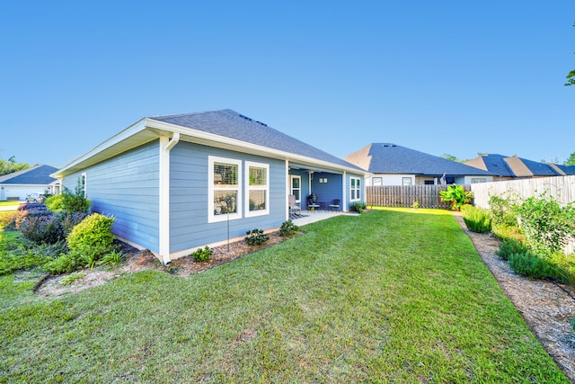 back of house with a patio area, ceiling fan, and a yard