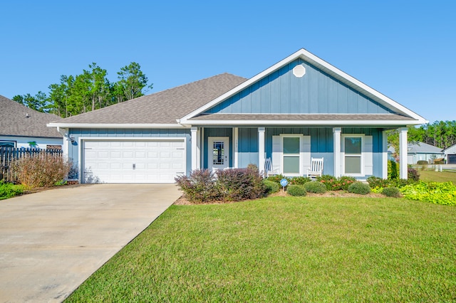 view of front of home with a garage and a front lawn