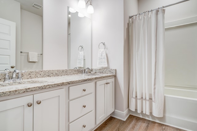 bathroom with vanity, shower / bath combo, and hardwood / wood-style flooring