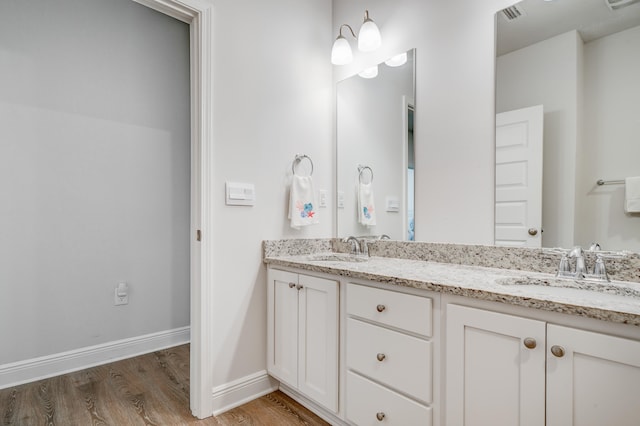 bathroom featuring vanity and wood-type flooring